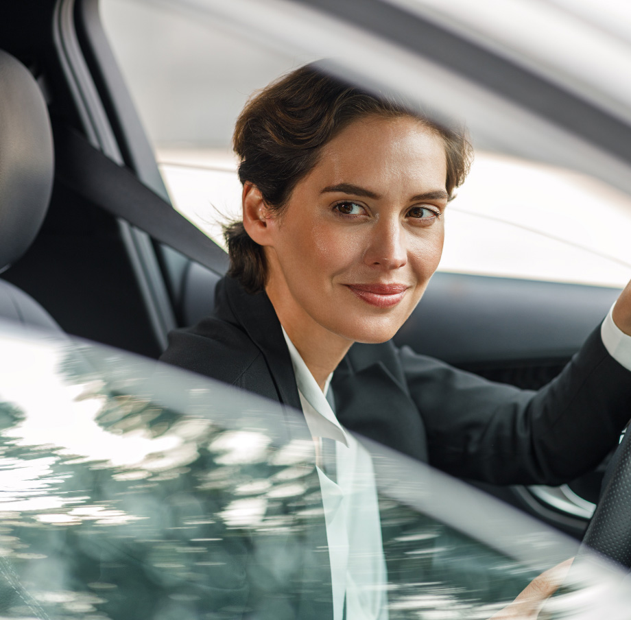 Woman driving looking outside